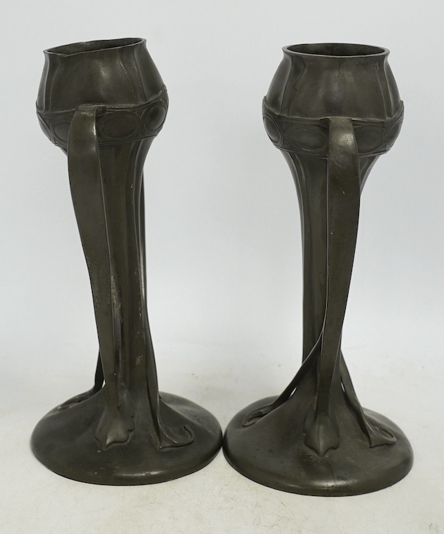 A pair of Art Nouveau Liberty Tudric pewter twin-handled vases, stamped to the bases, 25cm high. Condition - one good, the other poor to fair